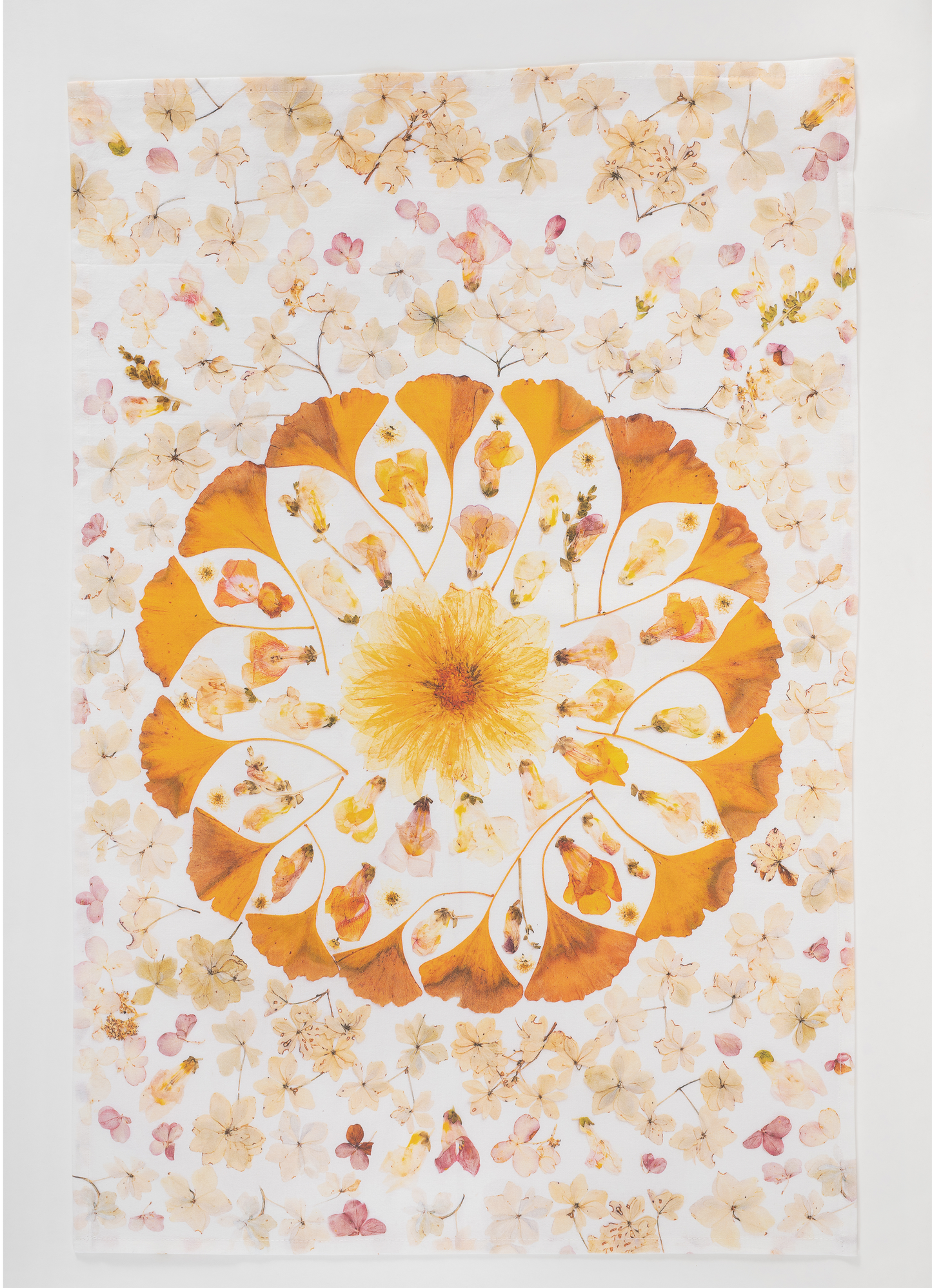 Pressed flower tea towel featuring botanical mandala artwork created using flowers from the artists garden.