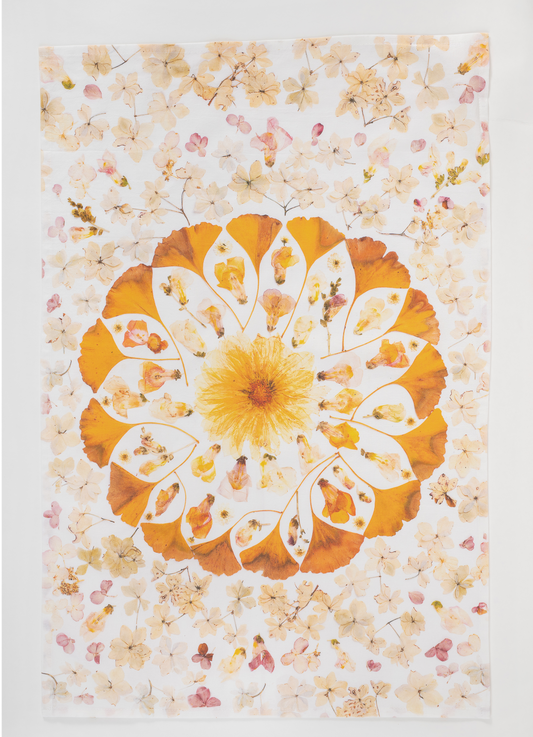 Pressed flower tea towel featuring botanical mandala artwork created using flowers from the artists garden.
