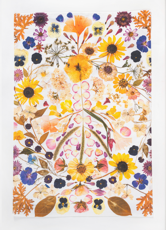 Pressed flower tea towel featuring a peace sign and botanical artwork created using flowers from the artist's garden.

